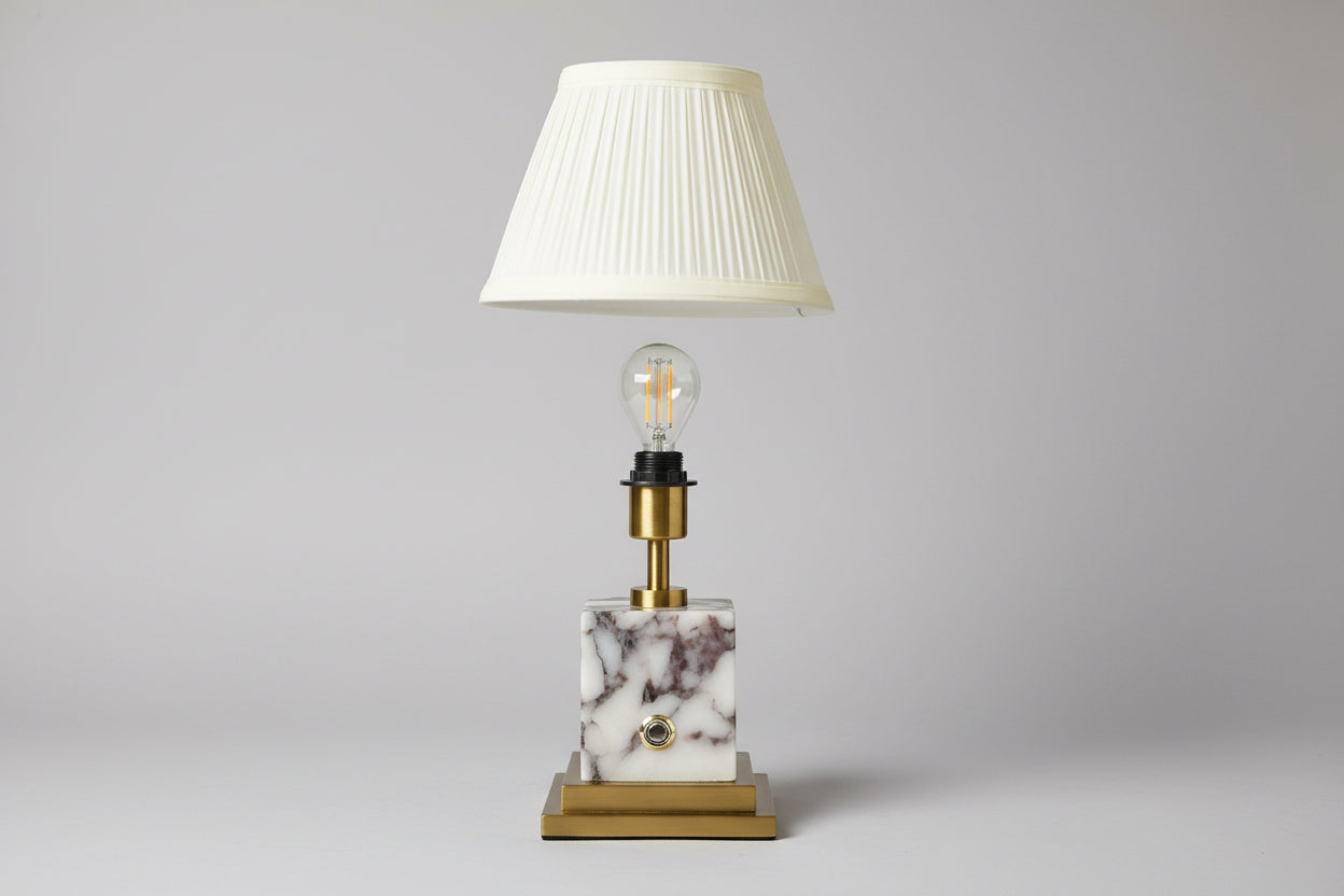 Rechargeable table lamp with marble base and popped up pleated white shade 